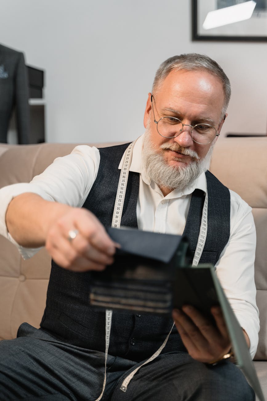 man in white long sleeve shirt holding black tablet computer