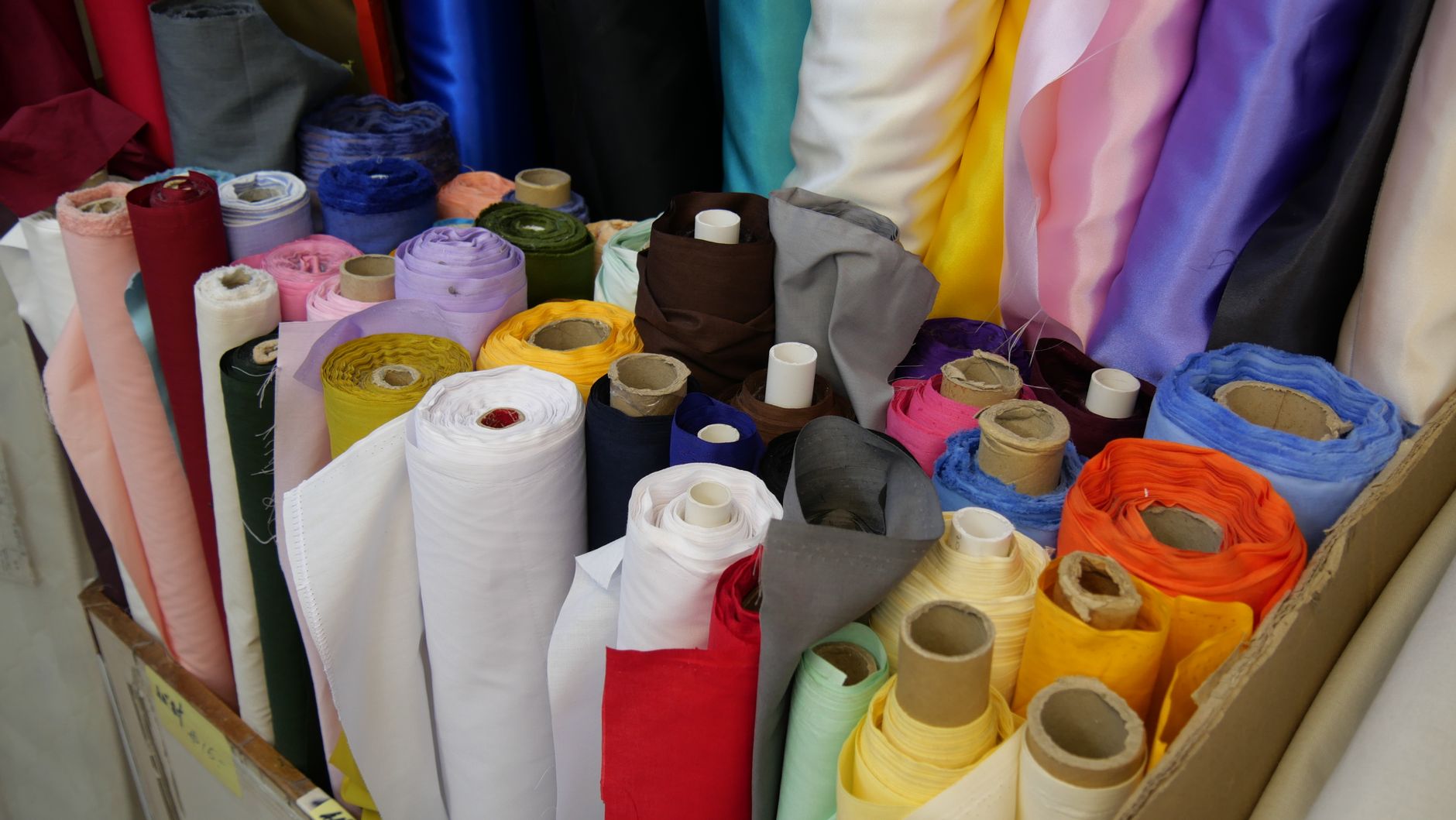 close up shot of assorted rolled textiles